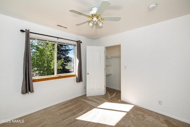 6120 E Treadway Trl, Flagstaff, AZ 86004 - unfurnished bedroom with carpet, baseboards, a spacious closet, and a ceiling fan