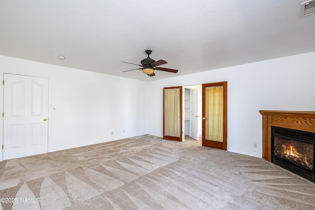 6120 E Treadway Trl, Flagstaff, AZ 86004 - unfurnished living room with carpet flooring, a ceiling fan, and a glass covered fireplace