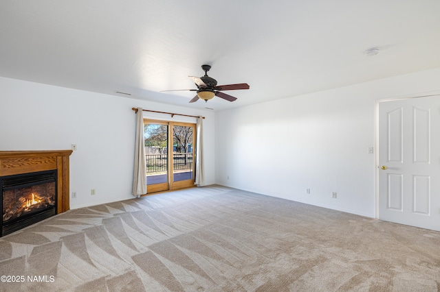 6120 E Treadway Trl, Flagstaff, AZ 86004 - unfurnished living room featuring a glass covered fireplace, carpet flooring, a ceiling fan, and baseboards