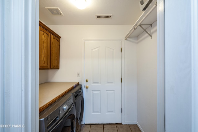 6120 E Treadway Trl, Flagstaff, AZ 86004 - laundry area featuring cabinet space, washing machine and clothes dryer, and light tile patterned flooring
