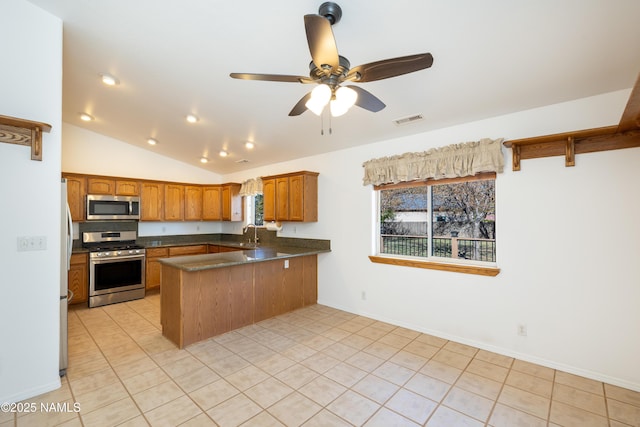 6120 E Treadway Trl, Flagstaff, AZ 86004 - kitchen with stainless steel appliances, a peninsula, brown cabinets, a sink, and light tile patterned floors