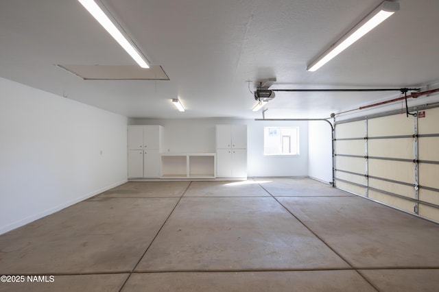6120 E Treadway Trl, Flagstaff, AZ 86004 - garage with baseboards and a garage door opener