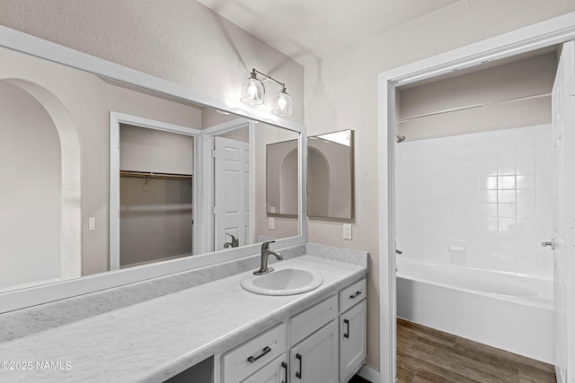 4343 E Soliere Ave Unit 2068, Flagstaff, AZ 86004 - bathroom with vanity, wood finished floors, a textured wall, and shower / bath combination