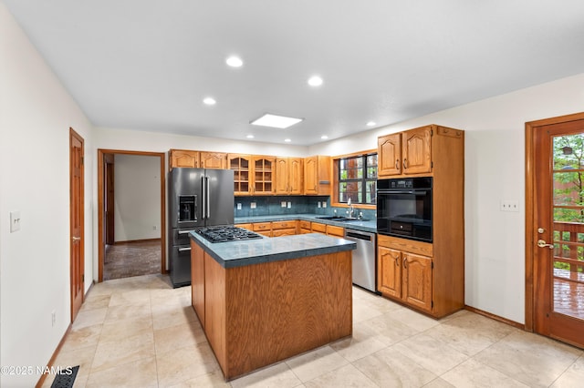 3130 Tina Ln, Flagstaff, AZ 86001 - kitchen with stainless steel appliances, dark countertops, recessed lighting, tasteful backsplash, and a kitchen island