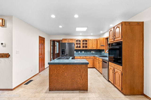 3130 Tina Ln, Flagstaff, AZ 86001 - kitchen featuring stainless steel appliances, a center island, decorative backsplash, glass insert cabinets, and recessed lighting