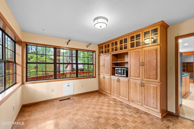 3130 Tina Ln, Flagstaff, AZ 86001 - unfurnished dining area with baseboards and a textured ceiling