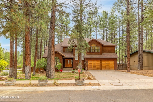 3130 Tina Ln, Flagstaff, AZ 86001 - view of front of home featuring a garage, concrete driveway, and roof with shingles