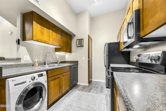 kitchen featuring light hardwood / wood-style flooring, dishwasher, sink, washer / clothes dryer, and black range with electric stovetop