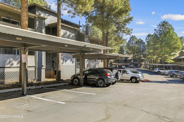 view of parking / parking lot featuring a carport