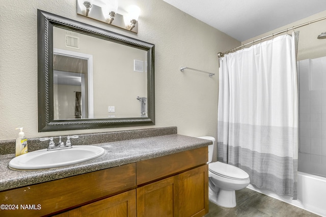 full bathroom featuring shower / bath combo with shower curtain, hardwood / wood-style floors, toilet, and vanity