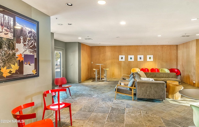 living room featuring wood walls