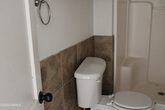 bathroom with toilet and a shower