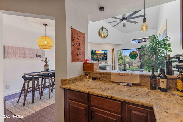 2315 N Whispering Pines Way, Flagstaff, AZ 86004 - kitchen featuring a ceiling fan, high vaulted ceiling, tile patterned floors, pendant lighting, and light stone counters