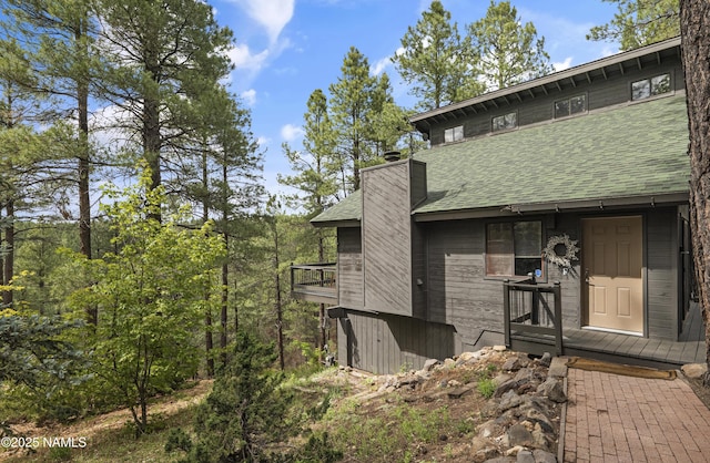 2929 Kletha Trl, Flagstaff, AZ 86005 - back of house featuring roof with shingles and a chimney