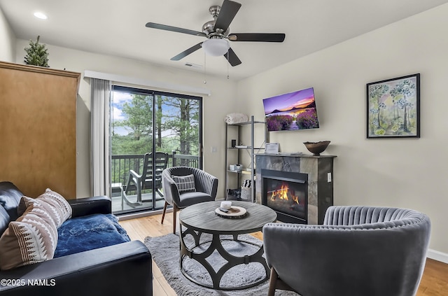 2929 Kletha Trl, Flagstaff, AZ 86005 - living area with wood finished floors, a fireplace, a ceiling fan, and recessed lighting