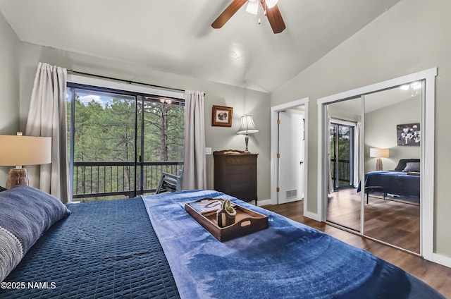 2929 Kletha Trl, Flagstaff, AZ 86005 - bedroom with multiple windows, vaulted ceiling, access to exterior, and wood finished floors