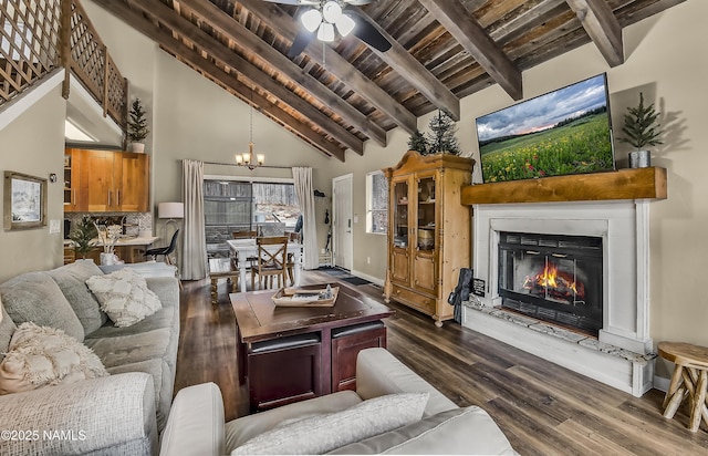 2929 Kletha Trl, Flagstaff, AZ 86005 - living room with dark wood-style flooring, wood ceiling with exposed beams, high vaulted ceiling, a chandelier, and a glass covered fireplace