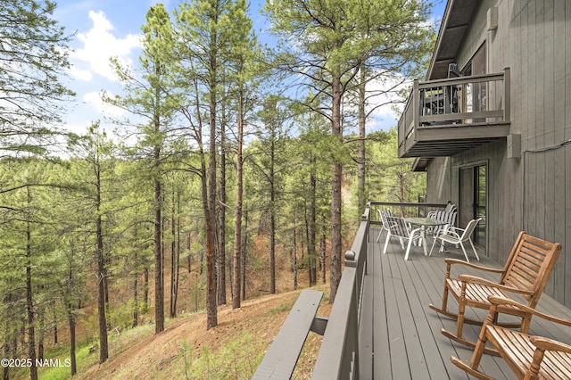2929 Kletha Trl, Flagstaff, AZ 86005 - wooden deck with outdoor dining space and a wooded view