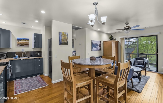 2929 Kletha Trl, Flagstaff, AZ 86005 - dining room featuring light wood-style floors, a ceiling fan, recessed lighting, a chandelier, and baseboards