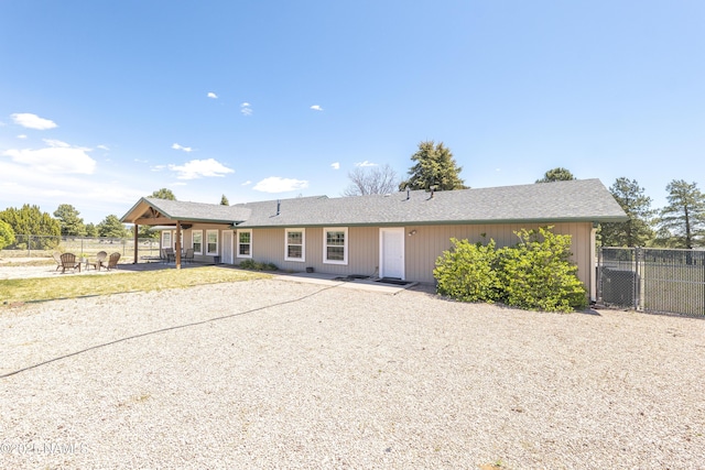 8210 Winchester Dr, Flagstaff, AZ 86004 - ranch-style house with a fire pit, fence, a patio, and a shingled roof