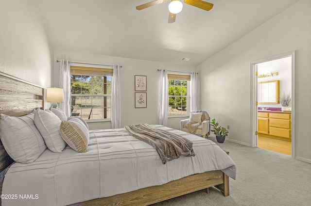 8210 Winchester Dr, Flagstaff, AZ 86004 - bedroom with carpet flooring, vaulted ceiling, connected bathroom, baseboards, and ceiling fan