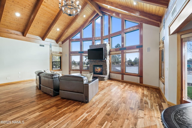 living room featuring light hardwood / wood-style flooring, high vaulted ceiling, wooden ceiling, a fireplace, and beamed ceiling