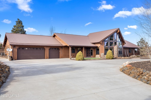 view of front of property featuring central AC unit and a garage