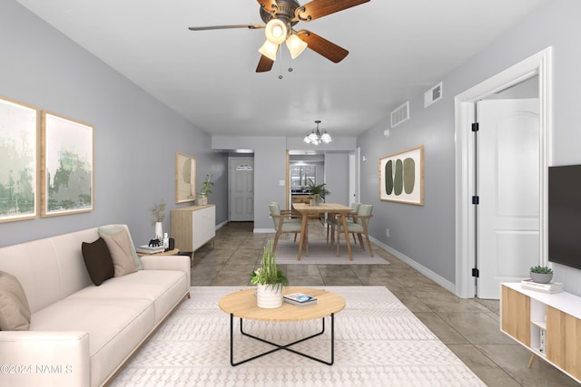 tiled living room featuring ceiling fan with notable chandelier