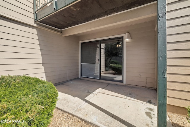 view of exterior entry featuring a patio