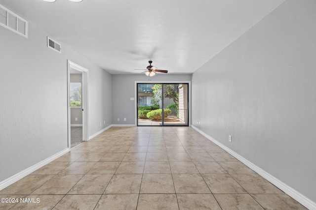 spare room with light tile patterned flooring and ceiling fan