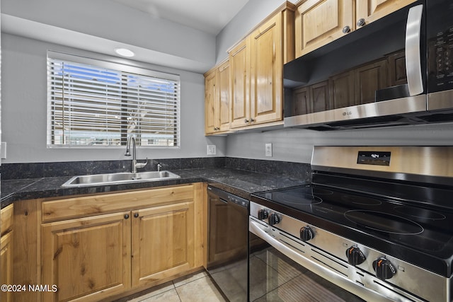 kitchen with sink, light tile patterned floors, and stainless steel appliances