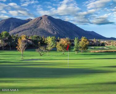 view of community with view of golf course and a mountain view