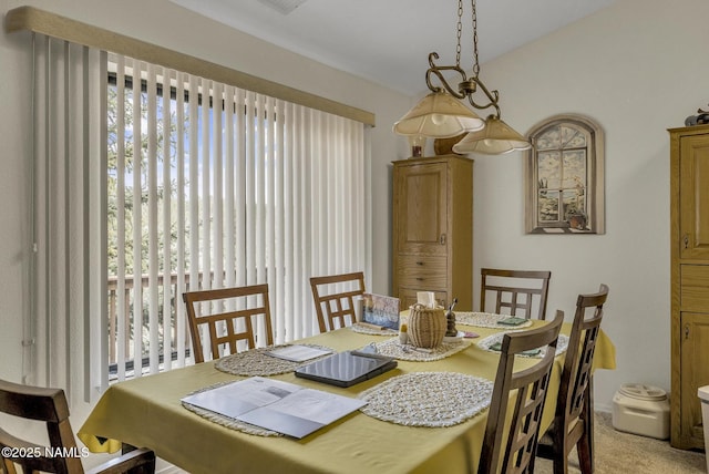 dining space featuring light colored carpet