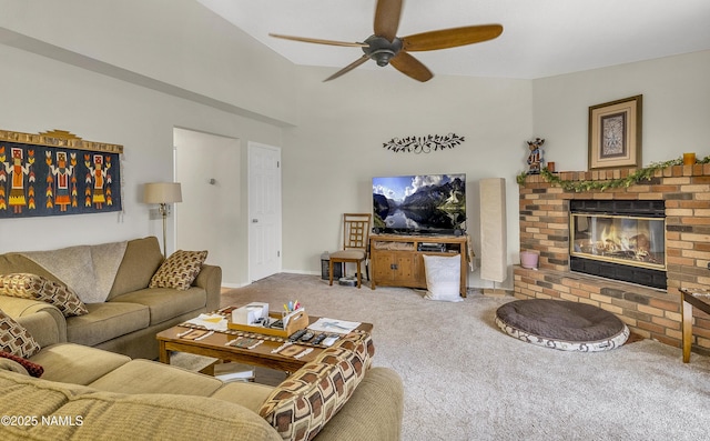 living area with carpet flooring, a ceiling fan, baseboards, and a fireplace