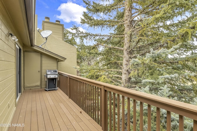 wooden terrace with area for grilling
