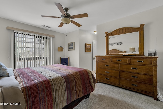 bedroom featuring light carpet, a ceiling fan, and visible vents