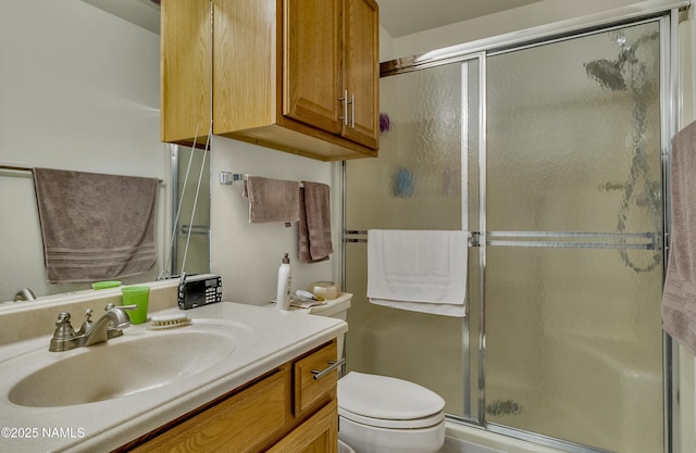 full bath featuring vanity, a stall shower, and toilet