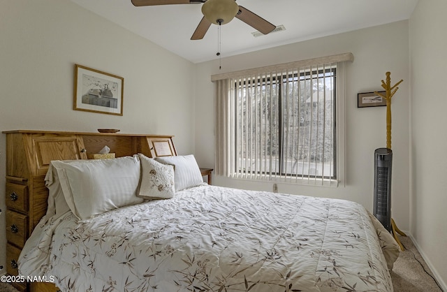 carpeted bedroom featuring ceiling fan, visible vents, and baseboards