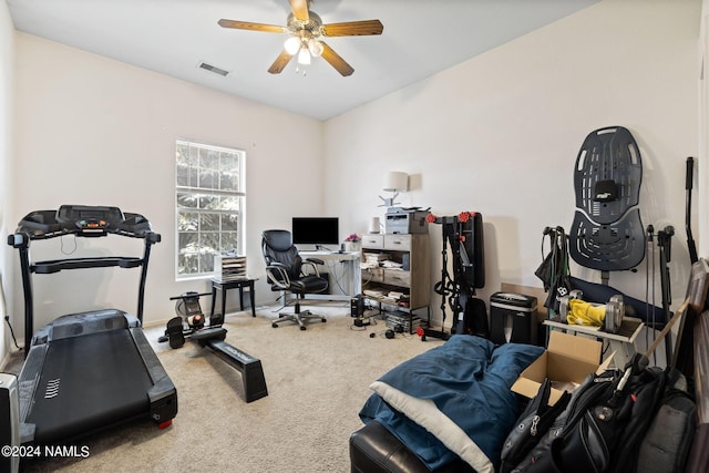 workout area with ceiling fan and carpet