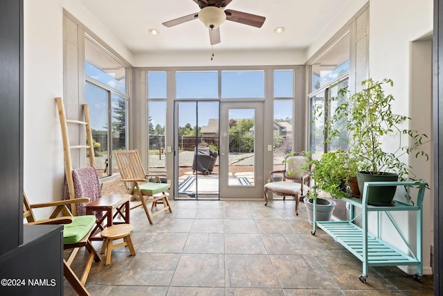 sunroom featuring ceiling fan