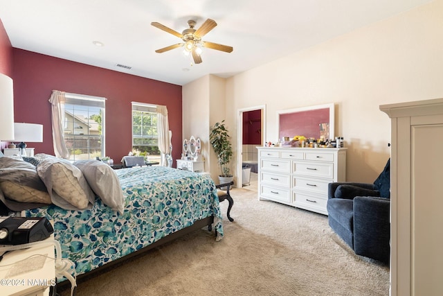 bedroom with ceiling fan and light carpet