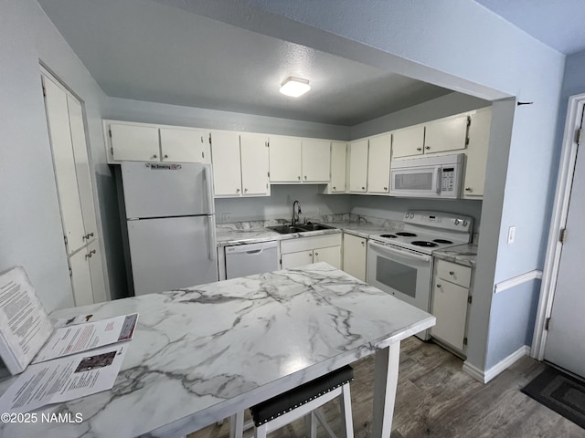 1200 S Riordan Ranch St Unit 44, Flagstaff, AZ 86001 - kitchen featuring white appliances, dark wood-style floors, white cabinetry, and wine cooler