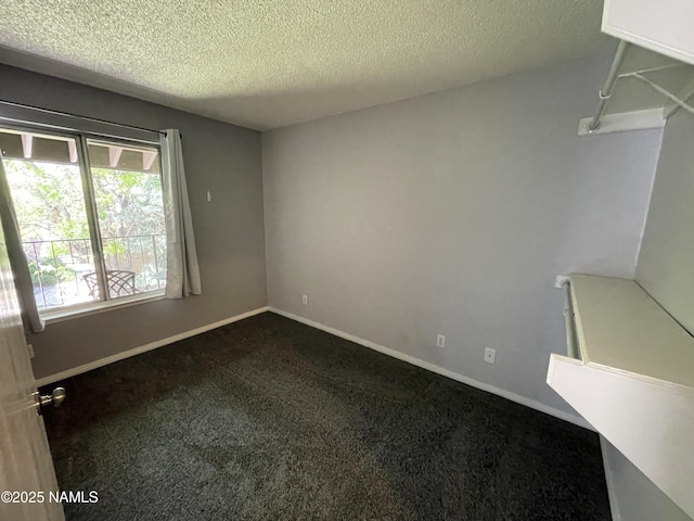 1200 S Riordan Ranch St Unit 44, Flagstaff, AZ 86001 - unfurnished room with dark carpet and a textured ceiling