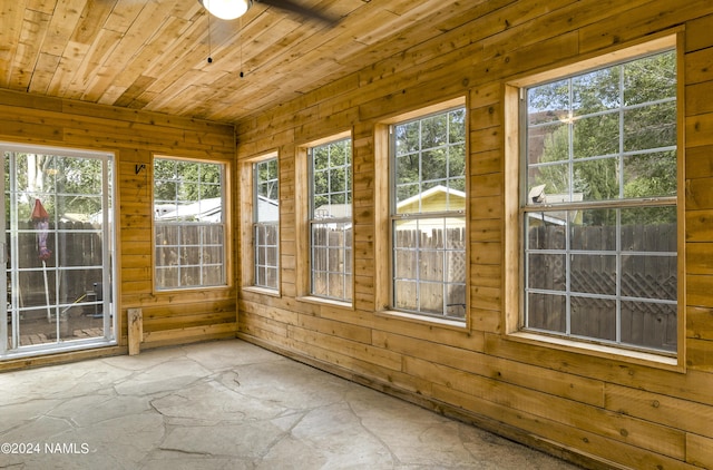 unfurnished sunroom with wood ceiling and a wealth of natural light