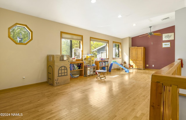 interior space with ceiling fan, vaulted ceiling, and light wood-type flooring