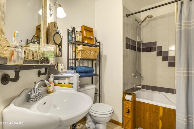 full bathroom featuring sink, toilet, and shower / tub combo with curtain