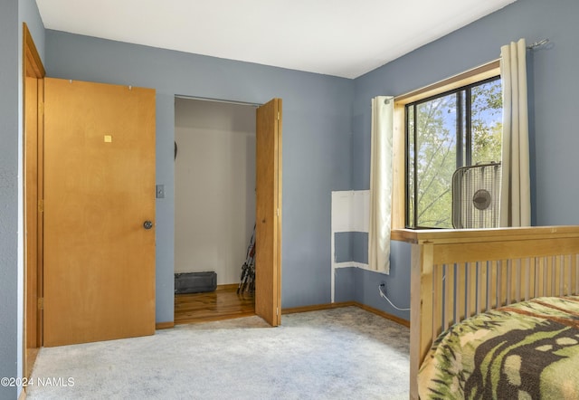 bedroom featuring light carpet