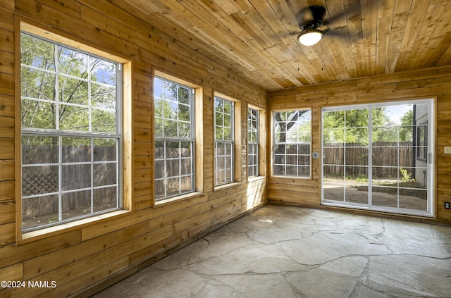 unfurnished sunroom with ceiling fan and wooden ceiling