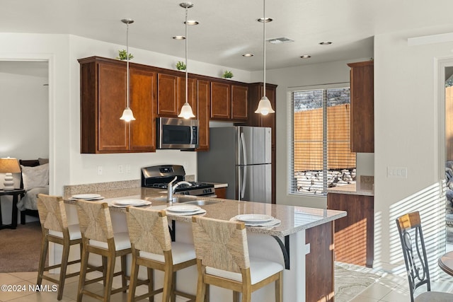 3008 E Cold Springs Trl, Flagstaff, AZ 86004 - kitchen featuring a peninsula, visible vents, appliances with stainless steel finishes, and light tile patterned floors