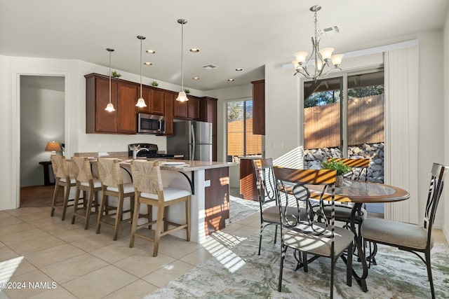 3008 E Cold Springs Trl, Flagstaff, AZ 86004 - kitchen featuring a breakfast bar, light tile patterned floors, light stone countertops, a peninsula, and appliances with stainless steel finishes